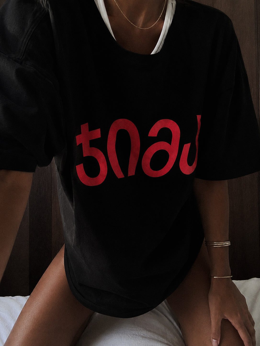 black "JIMA" t-shirt